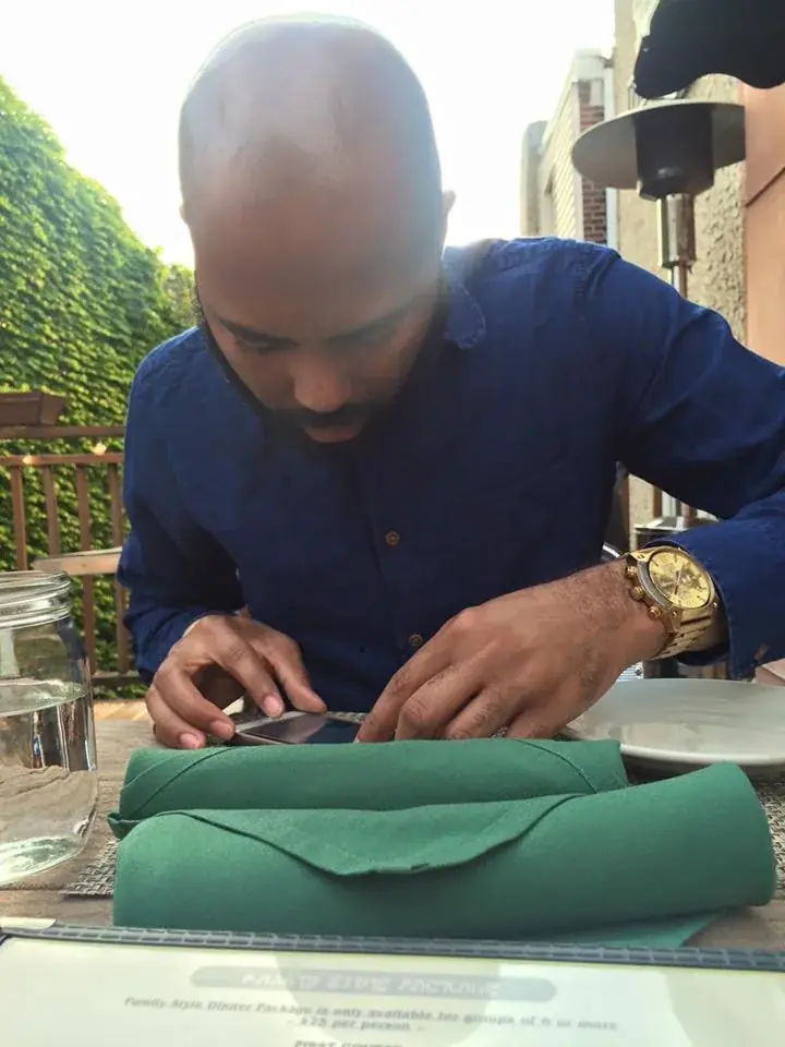 Folding a napkin at an outdoor dinner