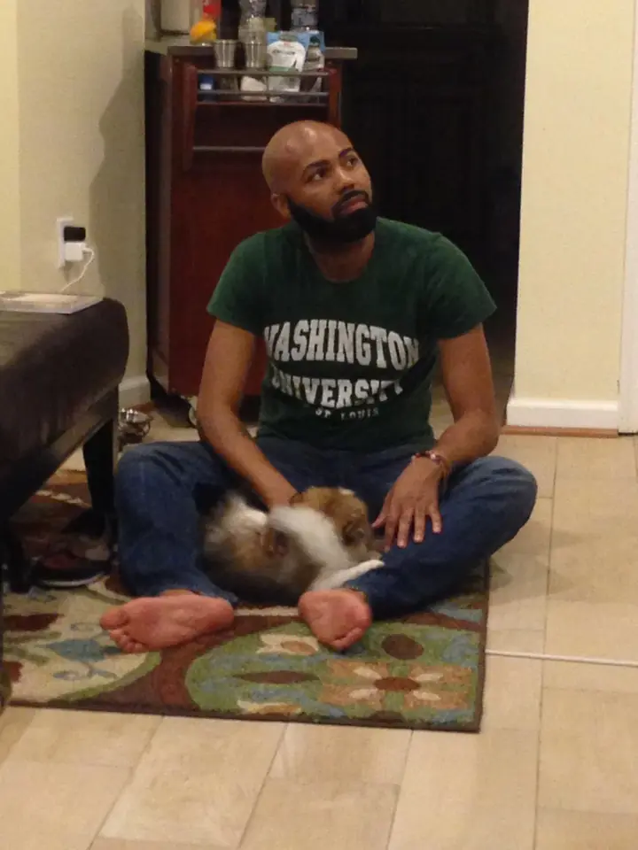 At home on the floor with the dog